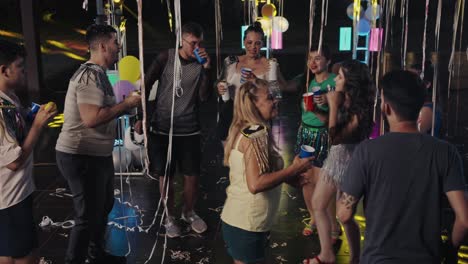 group of young adults enjoying a vibrant outdoor night party