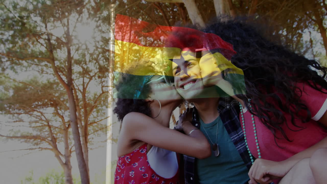 Three friends with Ghana flag overlay, walking outdoors, celebrating together