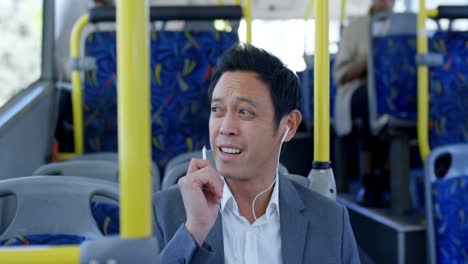 Male-commuter-using-earphone-while-travelling-in-bus-4k