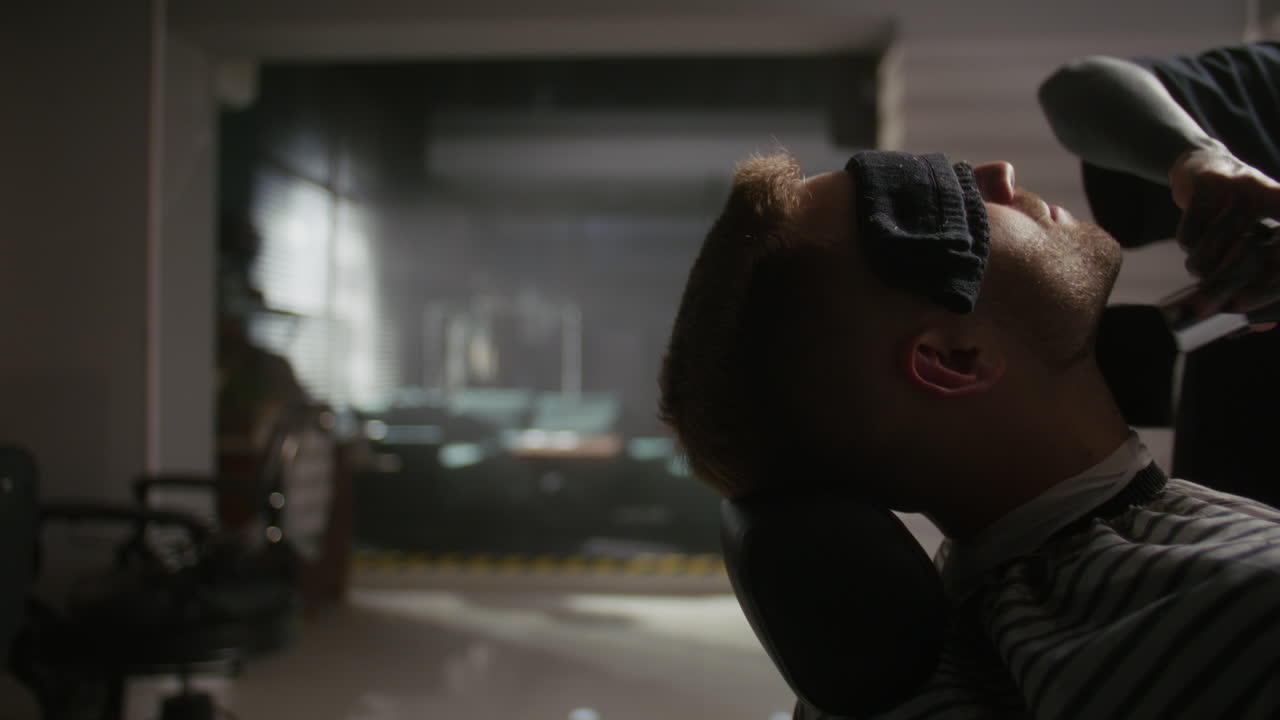 Man getting a haircut and shaving at the barbershop