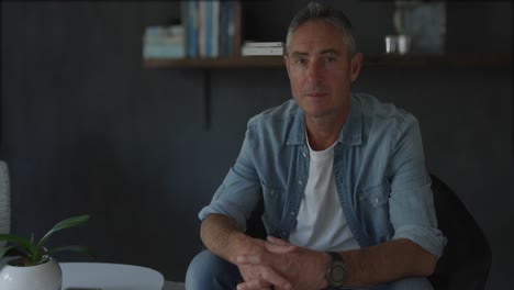man sitting at home at night