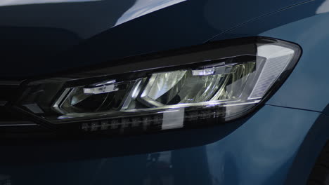 close-up of a modern car's headlight turning on and adjusting angle