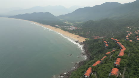 clifftop villas overlooking chan may bay in lang co vietnam on a misty humid morning