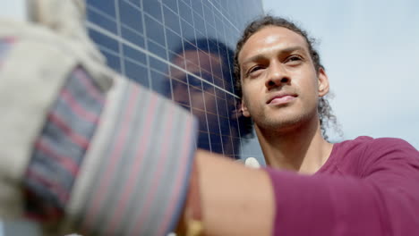 Busy-biracial-man-with-gloves-carrying-solar-panel-in-garden,-slow-motion