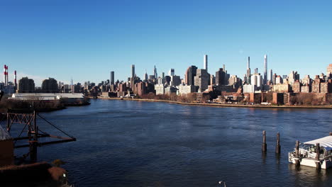 aerial view of yorkville district and the east river, in sunny new york, usa - reverse, drone shot