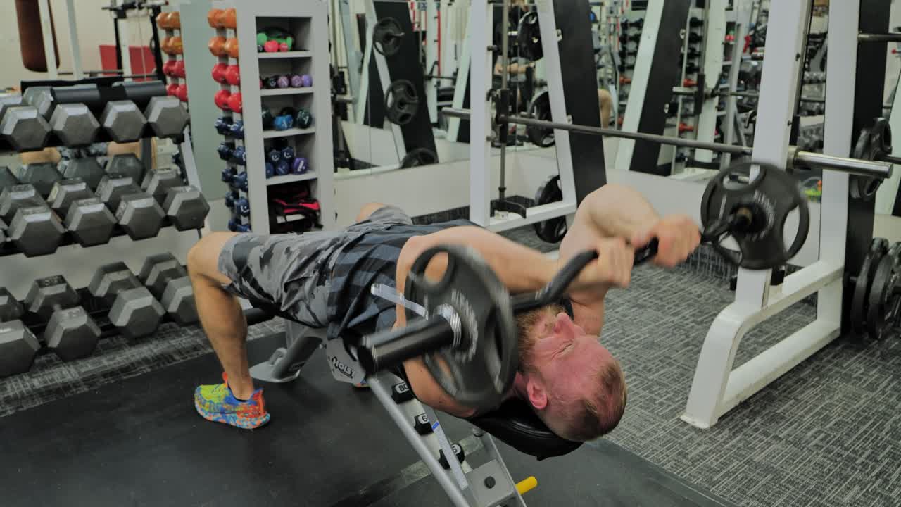 Young Adult Man Strenuously Working Out at Gym