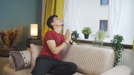 Christian-man-praying-in-front-of-the-window.