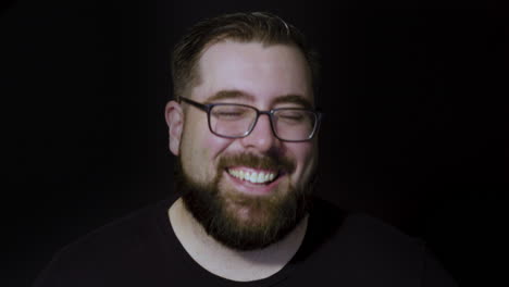 Motion-studio-portrait-of-a-cheerful-bearded-man,-happy-and-laughing