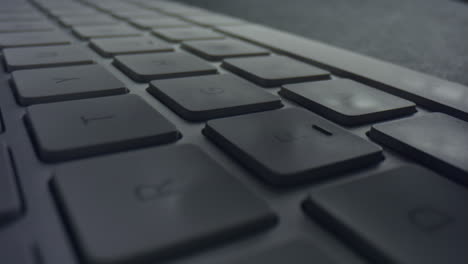 Macro-of-male-fingers-pressing-white-keys-on-computer-keyboard