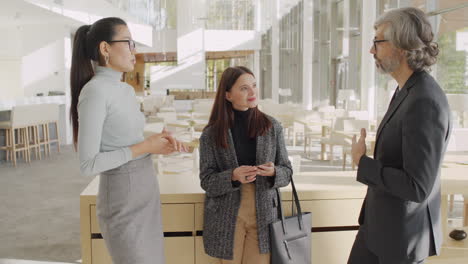 three professionals having a discussion in a modern business lounge