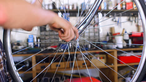 woman repairing cycle at workshop 4k