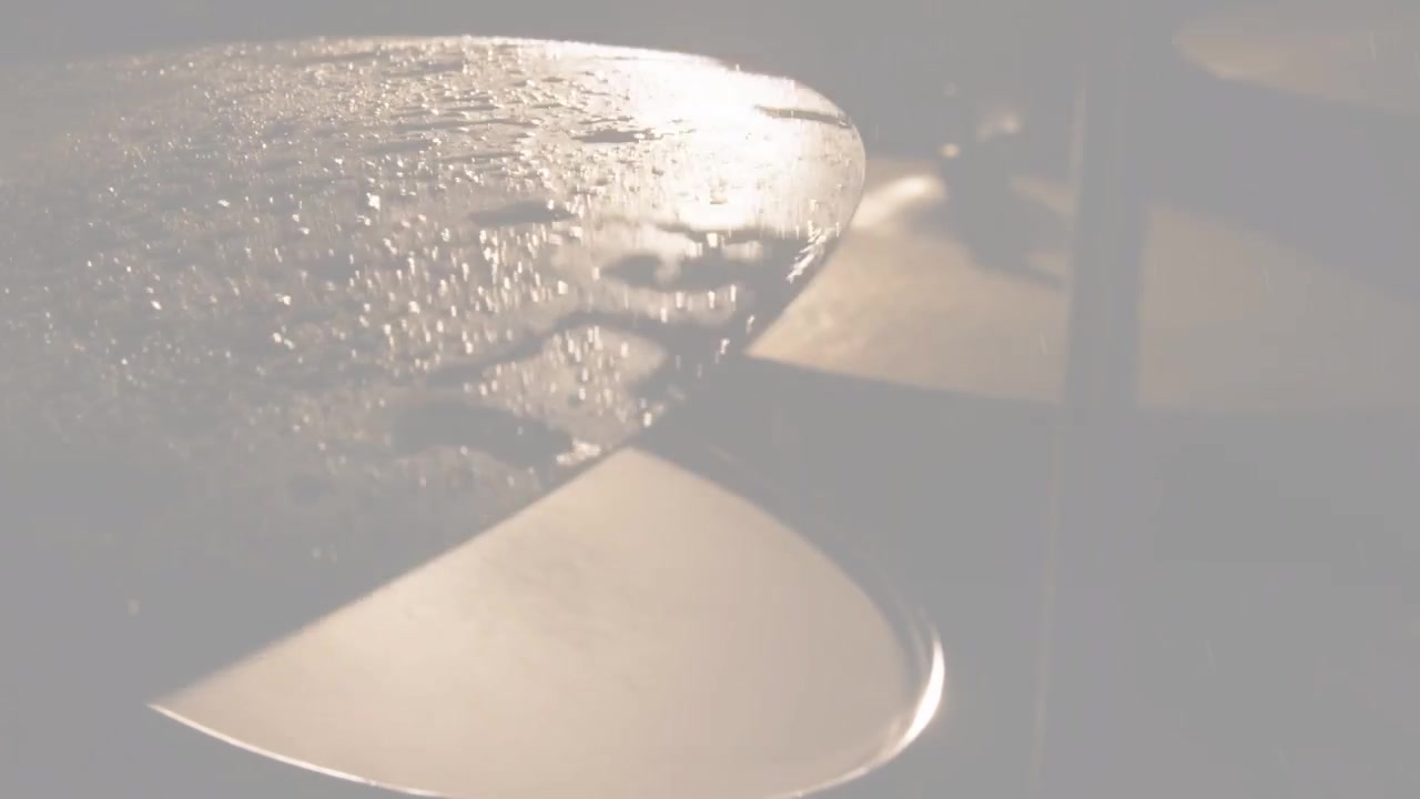Wet metal cymbal on left revealing beads as camera focus shifting glitch sweeping for music visuals
