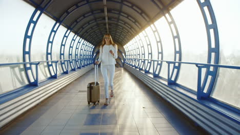 steadicam shot life in motion stylish woman with travel bag is on the sunlit move between terminals