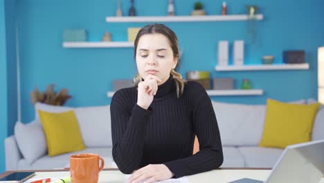 Thoughtful-portrait-of-young-entrepreneur-woman-working-in-home-office.