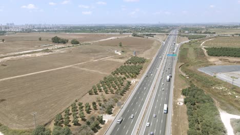 highway-runs-through-agricultural-fields,-A-sunny-summer-day-and-blue-sky