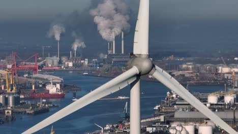 close up aerial drone shot of wind turbine spinning at the port of rotterdam, netherlands