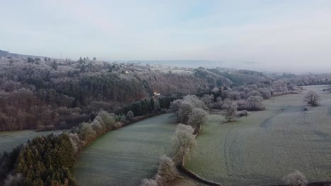 Aerial-view-of-the-beautiful-winter-landscape-and-farmland-in-Southern-Belgium