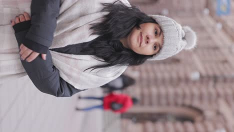 Vertical-View-Of-A-Brunette-Woman-Sightseeing-In-The-Old-Town-Of-Stockholm,-Sweden-During-Winter