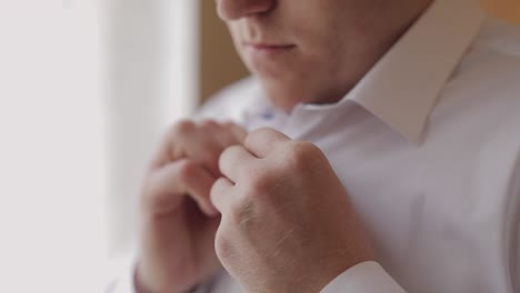 groom fixes his shirt. wedding morning. businessman. slow motion