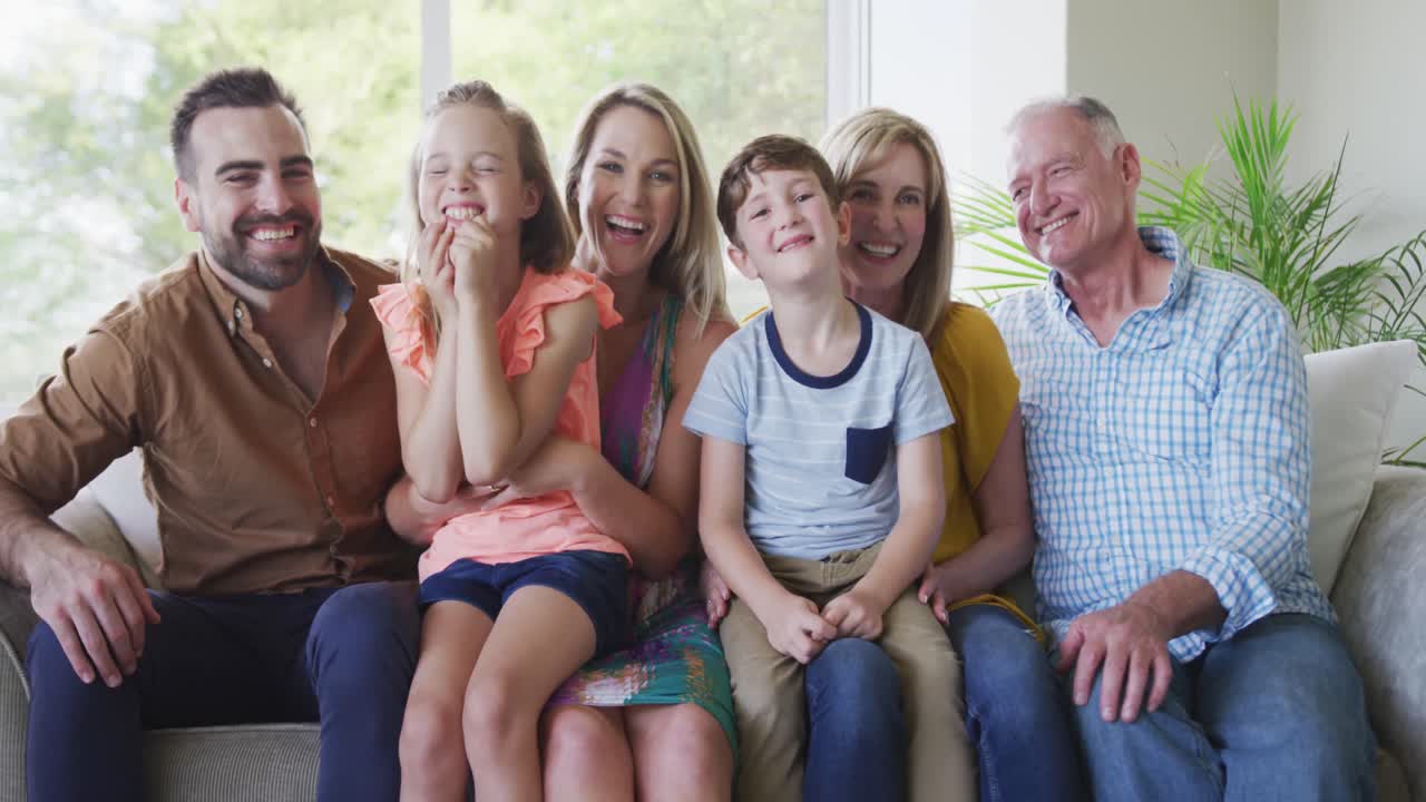 Portrait of six members of a multi-generation Caucasian family spending time at home together