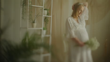 pregnant woman posing and dancing in italian style living room