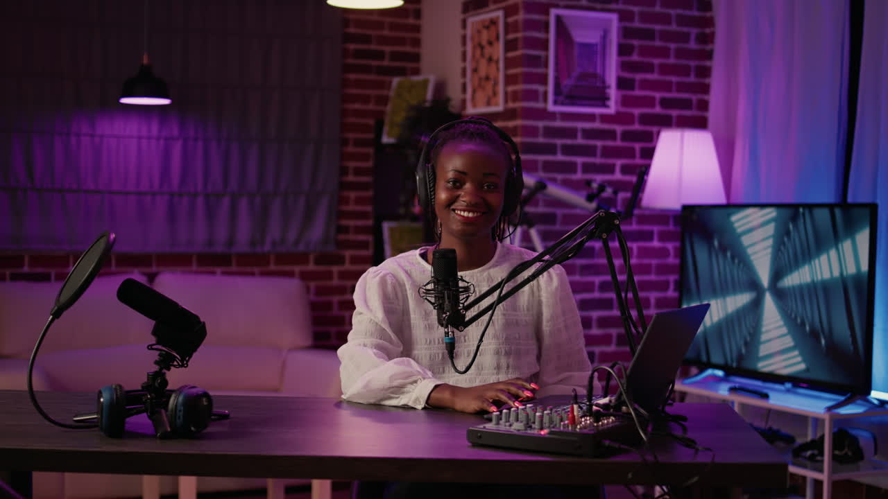Portrait of african american woman influencers reading content from laptop sitting at desk
