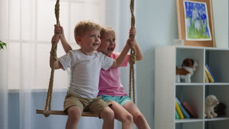 boy and girl siblings chat cheerfully sitting on swing