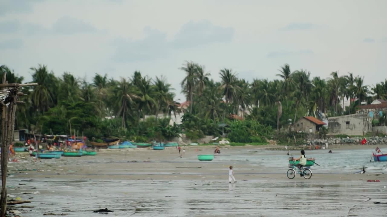 Mui Ne Beach Vietnam near to the Fishing Village - Traditional basket boats line the shores - Right to left panning shot