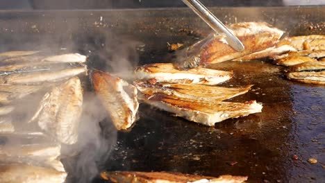 grilled fish being cooked on a hot plate