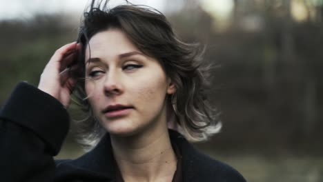 young woman in a black coat walking in a park in autumn in afternoon-7