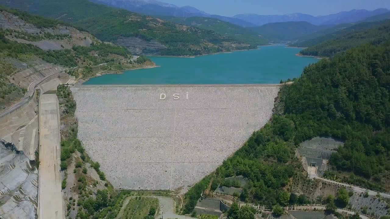 Aerial View of a Dam and Reservoir in a Mountainous Region