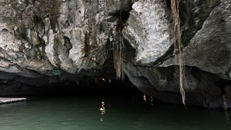 boat traverses through a serene water cave