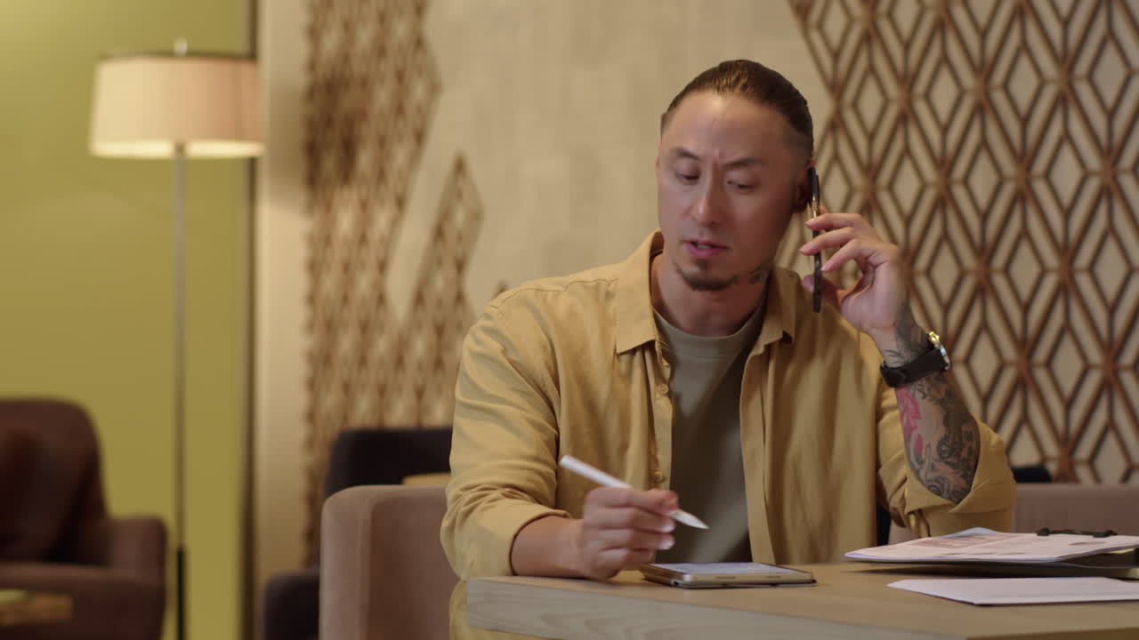 Multiethnic Businessman Talking on Phone with Client