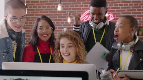 happy business people celebrating victory cheering excited enjoying watching entertainment on computer screen excited colleagues high five spontaneous celebration in office workplace