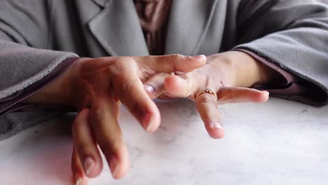 close up of a woman's hands with a ring on her finger