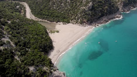 Cala-Sisine-Beach-At-Mouth-Of-Codula-Sisine-Stream-On-Coast-Of-Baunei,-Gulf-of-Orosei,-Sardinia,-Italy