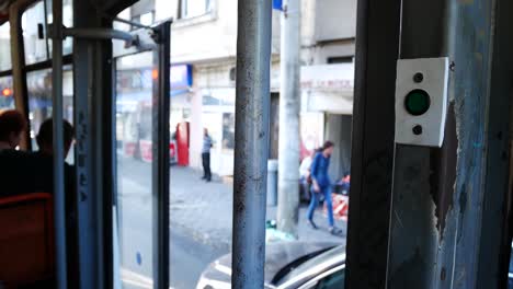 view from inside a moving tram showing city streets and people