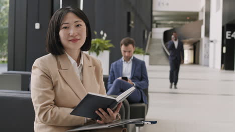 asian businesswoman doing paperwork in coworking space