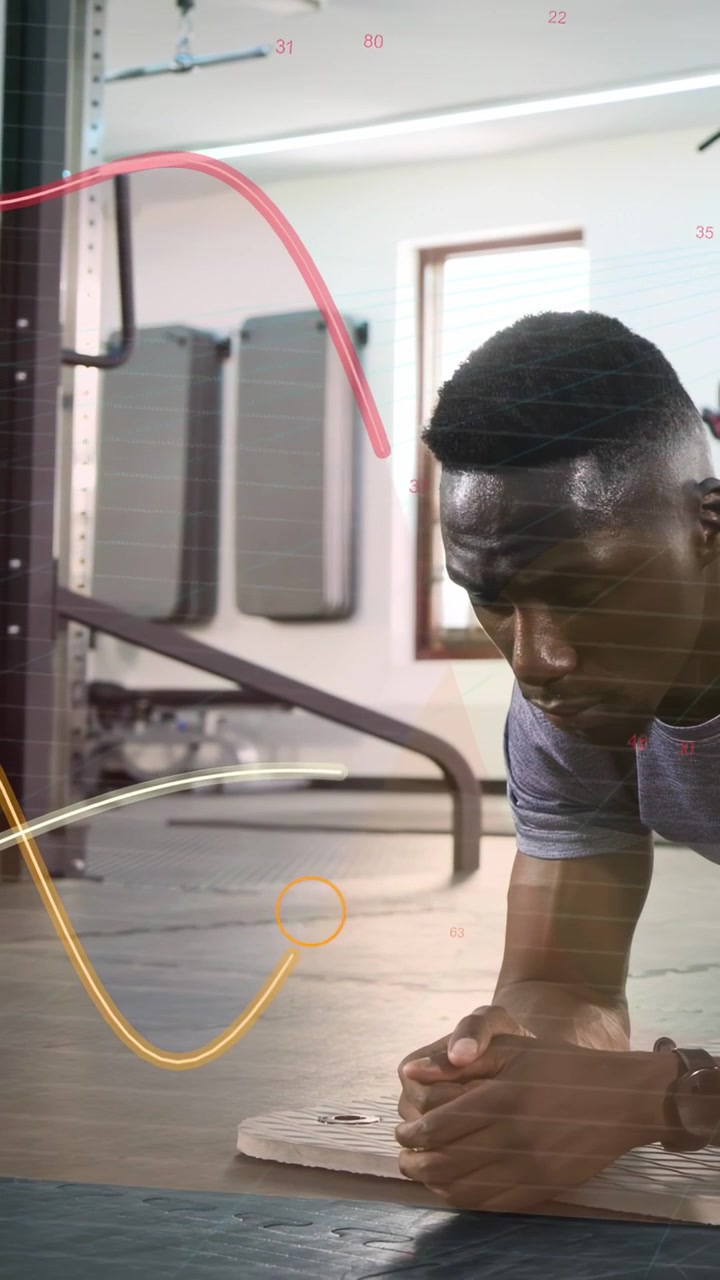 Vertical video: Man holding forearm plank in gym, frame revealing rack sparking waves toning core