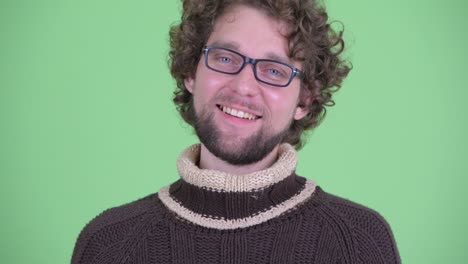 young handsome bearded man with curly hair