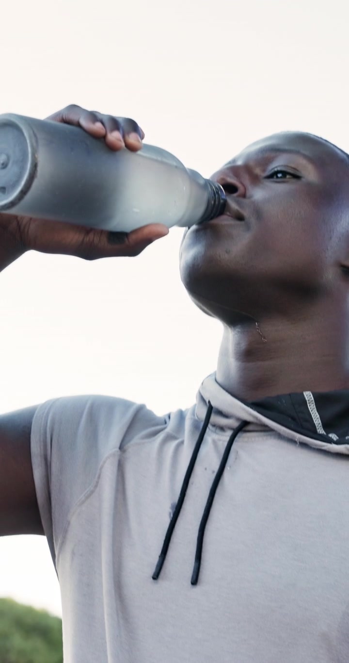Young Athletic Man Drinking Water After Workout