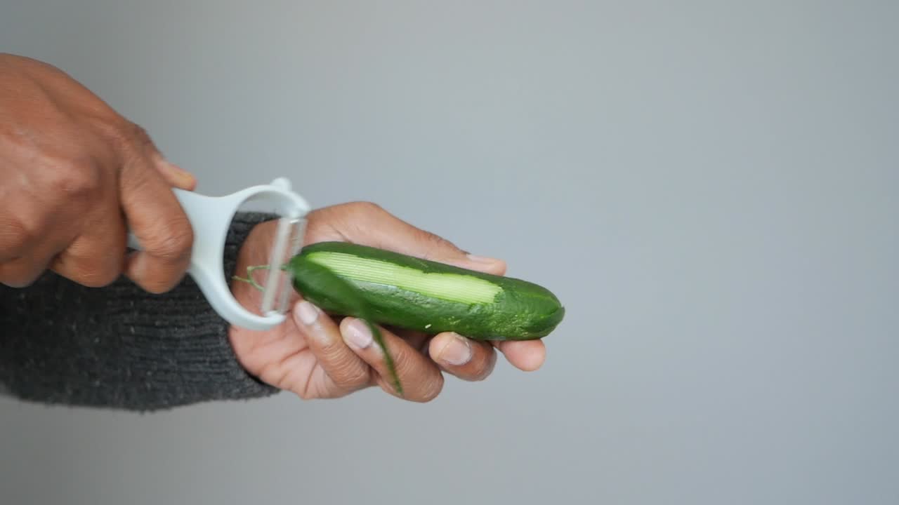 Peeling a cucumber