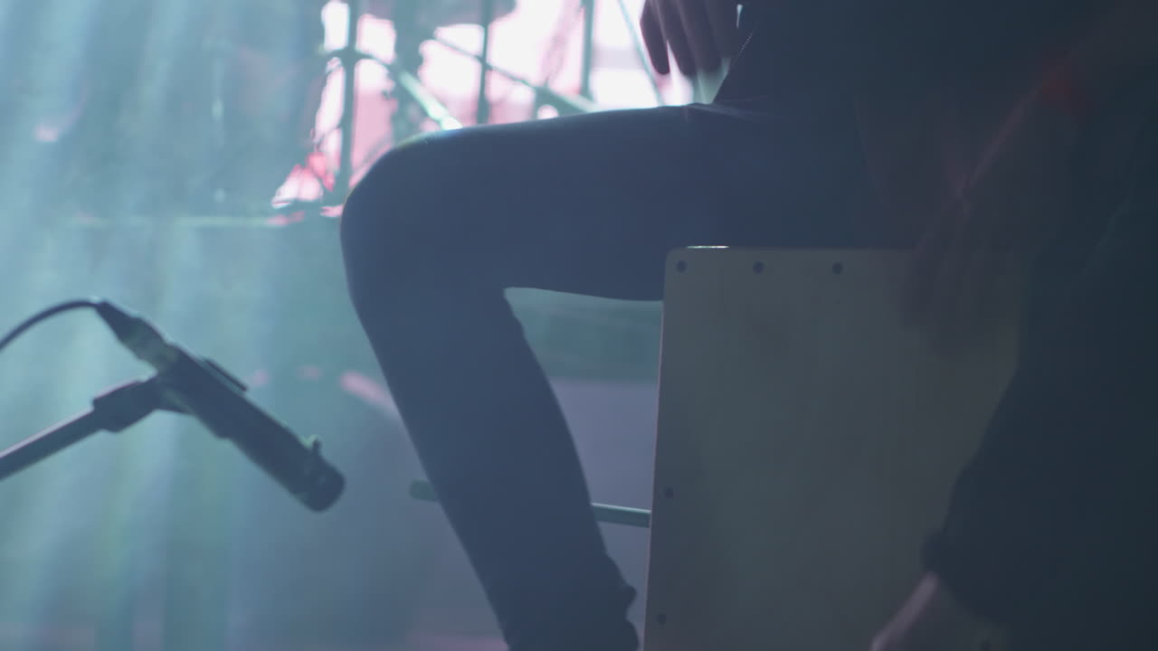 Musician playing cajon on stage