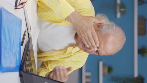 vertical video of home office worker old man has eye pain.