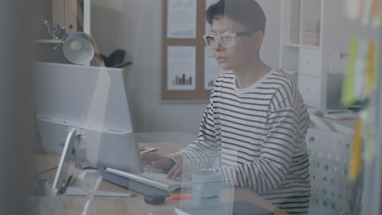 Young person working on a computer in an office