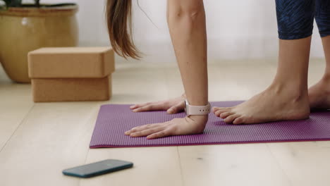 close up hands yoga woman exercising healthy lifestyle practicing downward-facing dog pose enjoying workout at home training on exercise mat