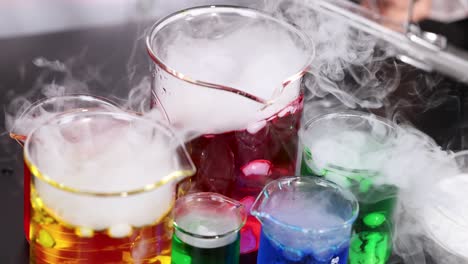 beakers with dry ice create colorful smoke effects