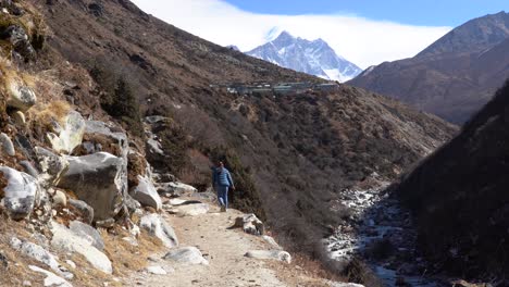 a person walking on a mountain trail in the himalaya mountains in nepal