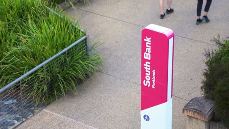 A-couple-walking-and-strolling-at-south-bank-parklands,-riverside-promenade,-the-recreational-precinct-at-Brisbane-city,-Queensland,-Australia