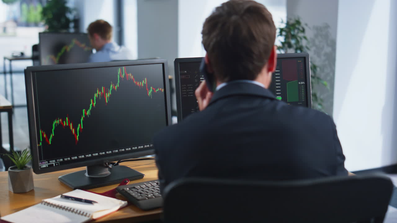 Stressed trader calling cellphone complaining financial loss at office closeup